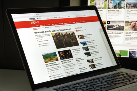 Milan, Italy - August 10, 2017: BBC website homepage. It is a British public service broadcaster headquartered at Broadcasting House in London. BBC logo visible.のeditorial素材