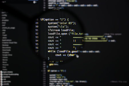 Real c / c++ code developing screen. Programing workflow abstract algorithm concept. Lines of c / c++ code visible under magnifying lens.の写真素材