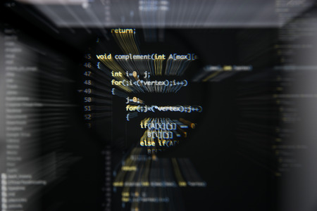 Real c  c code developing screen. Programing workflow abstract algorithm concept. Lines of c  c code visible under magnifying lens with moviment effect.の写真素材