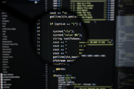 Real c  c code developing screen. Programing workflow abstract algorithm concept. Lines of c  c code visible under magnifying lens.の写真素材