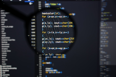 Real c  c code developing screen. Programing workflow abstract algorithm concept. Lines of c  c code visible under magnifying lens.の写真素材