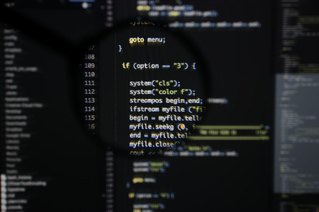 Real c  c code developing screen. Programing workflow abstract algorithm concept. Lines of c  c code visible under magnifying lens.の写真素材