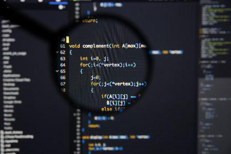 Real c  c code developing screen. Programing workflow abstract algorithm concept. Lines of c  c code visible under magnifying lens.の写真素材