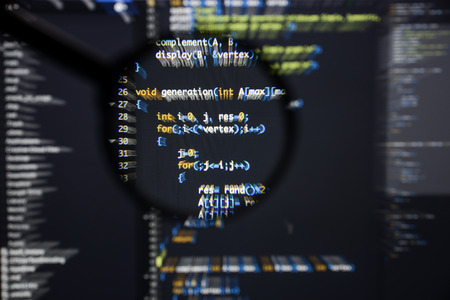 Real c  c code developing screen. Programing workflow abstract algorithm concept. Lines of c  c code visible under magnifying lens with moviment effect.の写真素材