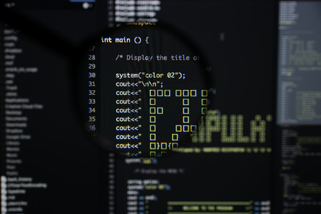 Real c  c code developing screen. Programing workflow abstract algorithm concept. Lines of c  c code visible under magnifying lens.の写真素材