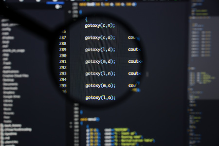 Real c  c code developing screen. Programing workflow abstract algorithm concept. Lines of c  c code visible under magnifying lens.の写真素材