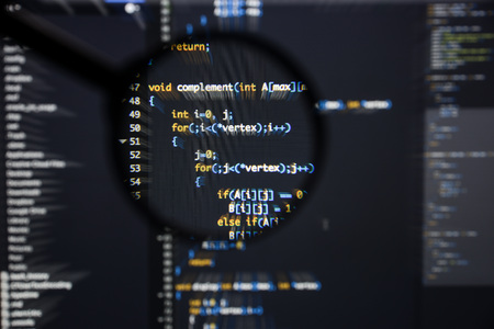 Real c  c code developing screen. Programing workflow abstract algorithm concept. Lines of c  c code visible under magnifying lens with moviment effect.の写真素材