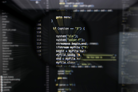 Real c  c code developing screen. Programing workflow abstract algorithm concept. Lines of c  c code visible under magnifying lens with moviment effect.の写真素材