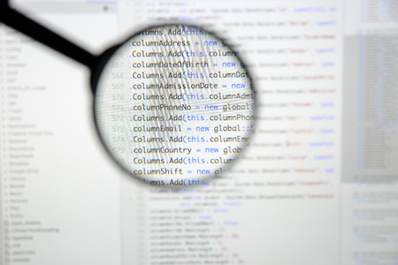 Real c code developing screen. Programing workflow abstract algorithm concept. Lines of c code visible under magnifying lens.の写真素材