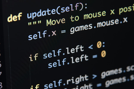 Real Python code developing screen. Programing workflow abstract algorithm concept. Lines of Python code visible under magnifying lens.の写真素材