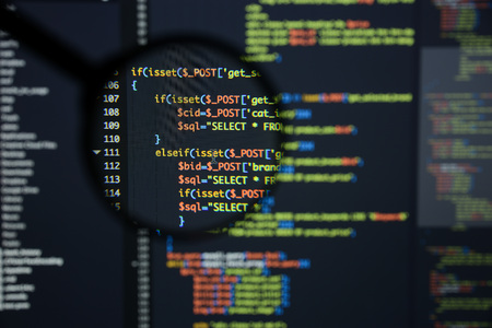 Real Php code developing screen. Programing workflow abstract algorithm concept. Lines of Php code visible under magnifying lens.の写真素材