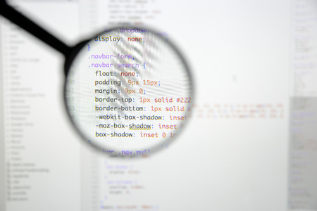 Real css code developing screen. Programing workflow abstract algorithm concept. Lines of css code visible under magnifying lens.の写真素材