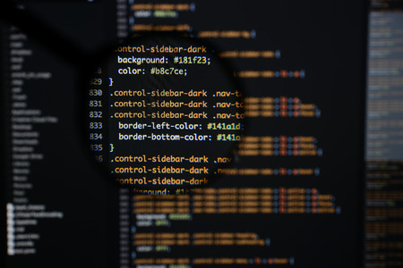 Real css code developing screen. Programing workflow abstract algorithm concept. Lines of css code visible under magnifying lens.の写真素材