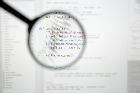 Real Python code developing screen. Programing workflow abstract algorithm concept. Lines of Python code visible under magnifying lens.の写真素材