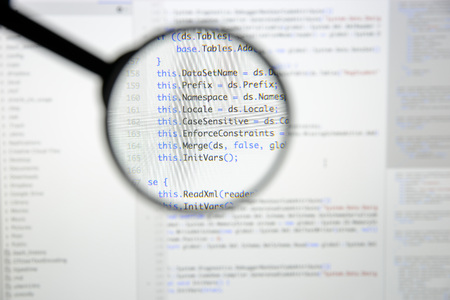 Real c code developing screen. Programing workflow abstract algorithm concept. Lines of c code visible under magnifying lens.の写真素材
