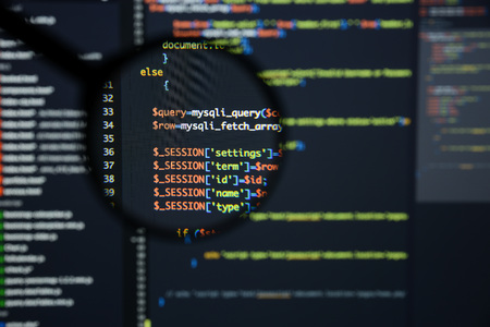 Real Php code developing screen. Programing workflow abstract algorithm concept. Lines of Php code visible under magnifying lens.の写真素材