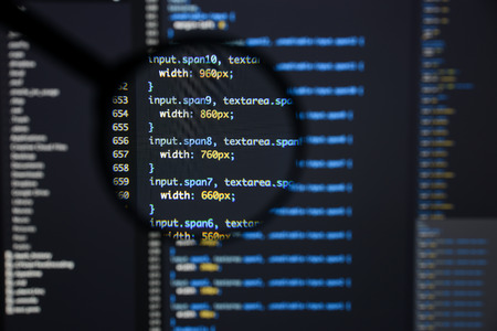 Real css code developing screen. Programing workflow abstract algorithm concept. Lines of css code visible under magnifying lens.の写真素材