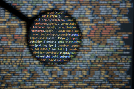 Real css code developing screen. Programing workflow abstract algorithm concept. Lines of css code visible under magnifying lens.の写真素材
