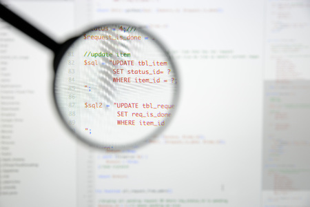 Real Php code developing screen. Programing workflow abstract algorithm concept. Lines of Php code visible under magnifying lens.の写真素材