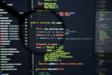 Real Php code developing screen. Programing workflow abstract algorithm concept. Lines of Php code visible under magnifying lens.の写真素材