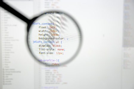 Real css code developing screen. Programing workflow abstract algorithm concept. Lines of css code visible under magnifying lens.の写真素材