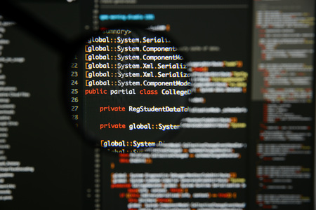 Real c code developing screen. Programing workflow abstract algorithm concept. Lines of c code visible under magnifying lens.の写真素材