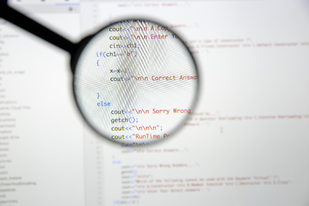 Real c  c code developing screen. Programing workflow abstract algorithm concept. Lines of c  c code visible under magnifying lens.の写真素材