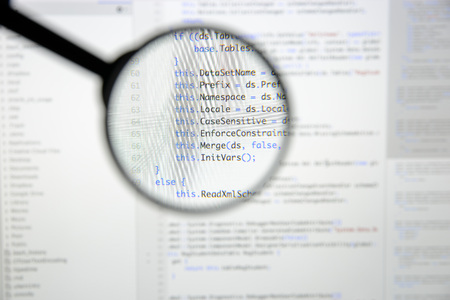 Real c code developing screen. Programing workflow abstract algorithm concept. Lines of c code visible under magnifying lens.の写真素材