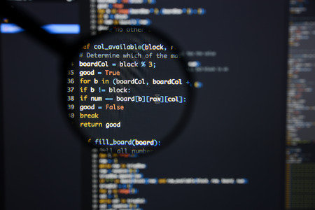 Real Python code developing screen. Programing workflow abstract algorithm concept. Lines of Python code visible under magnifying lens.の写真素材