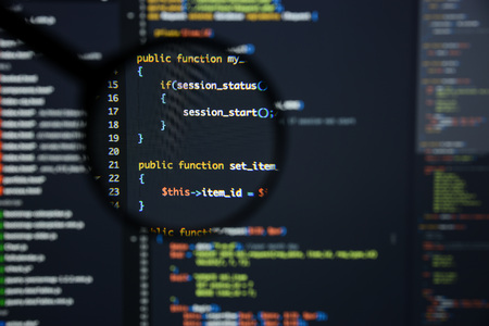 Real Php code developing screen. Programing workflow abstract algorithm concept. Lines of Php code visible under magnifying lens.の写真素材