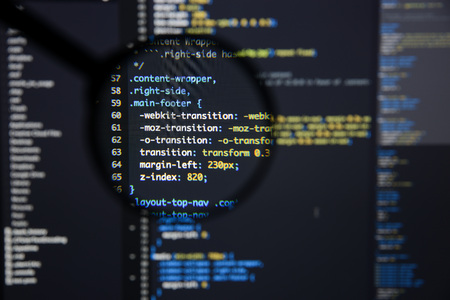 Real css code developing screen. Programing workflow abstract algorithm concept. Lines of css code visible under magnifying lens.の写真素材
