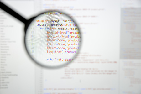 Real Php code developing screen. Programing workflow abstract algorithm concept. Lines of Php code visible under magnifying lens.の写真素材