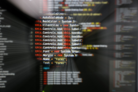 Real c code developing screen. Programing workflow abstract algorithm concept. Lines of c code visible under magnifying lens  with moviment effect.の写真素材