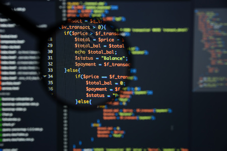 Real Php code developing screen. Programing workflow abstract algorithm concept. Lines of Php code visible under magnifying lens.の写真素材
