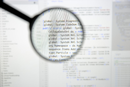 Real c code developing screen. Programing workflow abstract algorithm concept. Lines of c code visible under magnifying lens.の写真素材