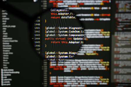 Real c code developing screen. Programing workflow abstract algorithm concept. Lines of c code visible under magnifying lens.の写真素材