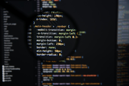Real css code developing screen. Programing workflow abstract algorithm concept. Lines of css code visible under magnifying lens.の写真素材