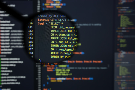 Real Php code developing screen. Programing workflow abstract algorithm concept. Lines of Php code visible under magnifying lens.の写真素材