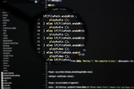 Real c / c++ code developing screen. Programing workflow abstract algorithm concept. Lines of c / c++ code visible under magnifying lens.の写真素材