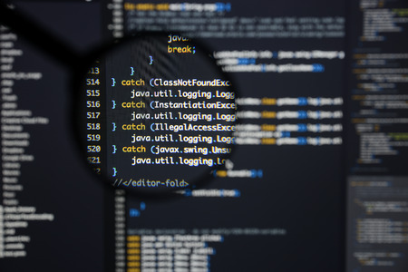 Real Java code developing screen. Programing workflow abstract algorithm concept. Lines of Java code visible under magnifying lens.の写真素材