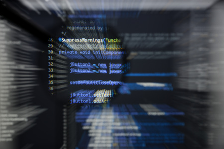 Real Java code developing screen. Programing workflow abstract algorithm concept. Lines of Java code visible under magnifying lens with moviment effectの写真素材