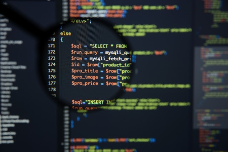 Real Php code developing screen. Programing workflow abstract algorithm concept. Lines of Php code visible under magnifying lens.の写真素材