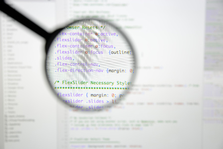 Real css code developing screen. Programing workflow abstract algorithm concept. Lines of css code visible under magnifying lens.の写真素材