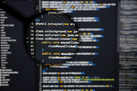 Real Java code developing screen. Programing workflow abstract algorithm concept. Lines of Java code visible under magnifying lens.の写真素材