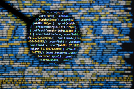 Real css code developing screen. Programing workflow abstract algorithm concept. Lines of css code visible under magnifying lens.の写真素材