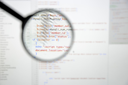 Real Php code developing screen. Programing workflow abstract algorithm concept. Lines of Php code visible under magnifying lens.の写真素材