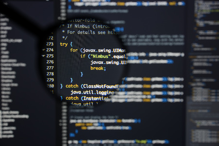 Real Java code developing screen. Programing workflow abstract algorithm concept. Lines of Java code visible under magnifying lens.の写真素材