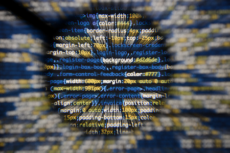 Real css code developing screen. Programing workflow abstract algorithm concept. Lines of css code visible under magnifying lens with moviment effect.の写真素材