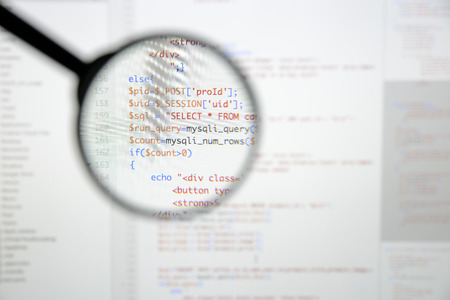Real Php code developing screen. Programing workflow abstract algorithm concept. Lines of Php code visible under magnifying lens.の写真素材