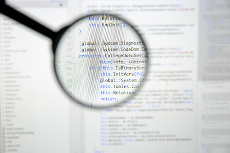 Real c# code developing screen. Programing workflow abstract algorithm concept. Lines of c# code visible under magnifying lens.の写真素材